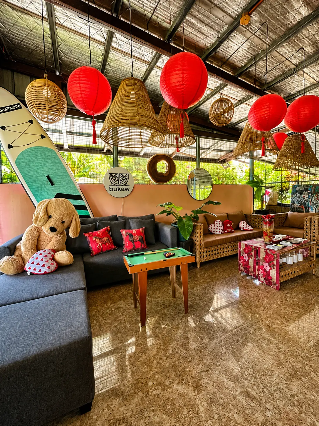 Bukaw welcome area with owl collection, art, and rustic wooden table