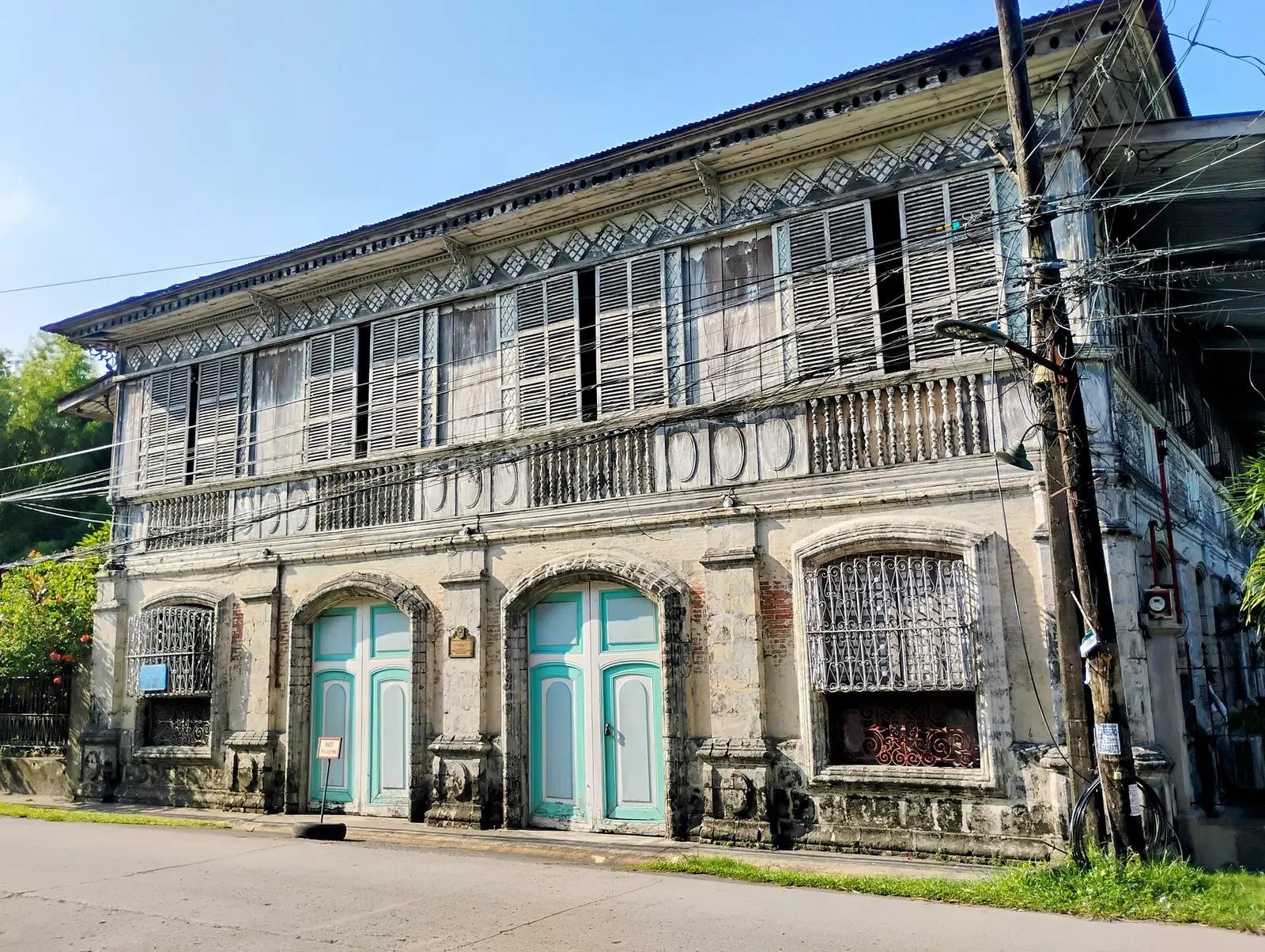 Balay ni Tana Dicang in Talisay, a white ancestral house with a red roof and a porch