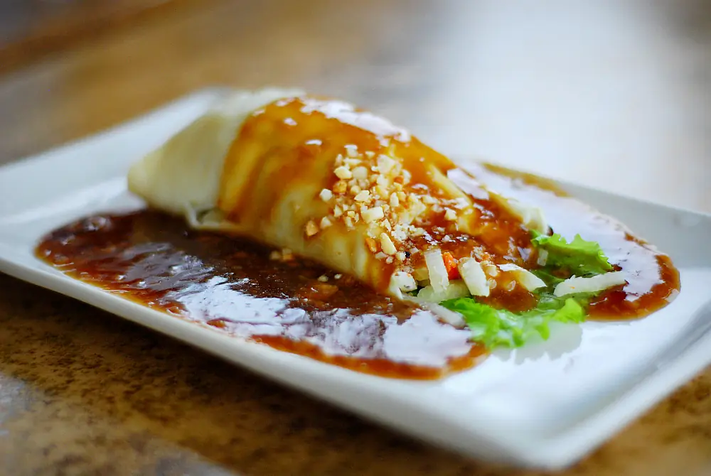 Lumpiang ubod, a fresh heart-of-palm spring roll with a garlic sauce