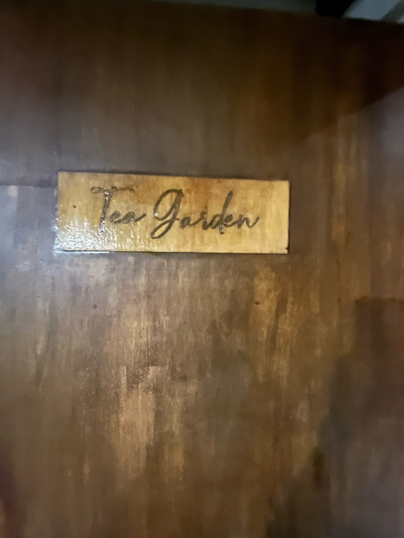 Wooden Tea Garden sign among the leaves at Mambukal.