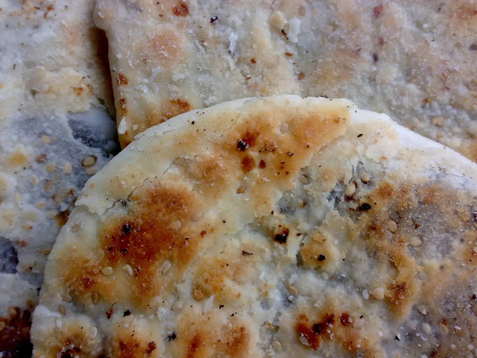 Round piaya flatbreads, filled and topped with sesame